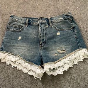 Free people denim shorts with lace detailing